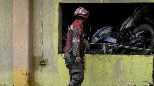 Neighbors, rescuers search for 52 missing after Venezuela landslide