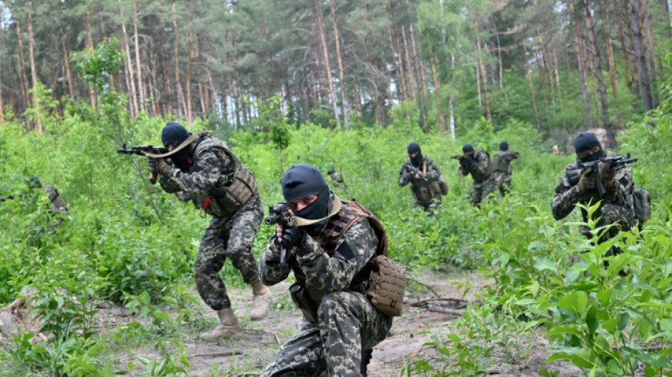 Ukrainians train with army in Bucha base abandoned by Russia